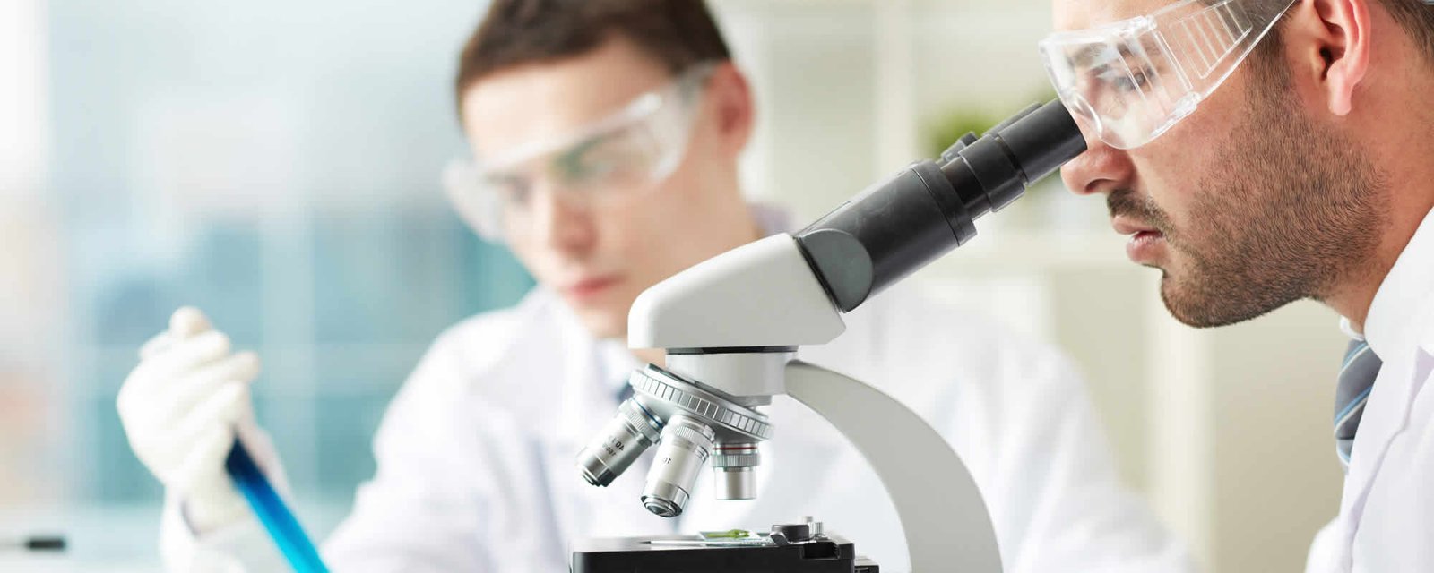 Pathologist examining a sample under a microscope